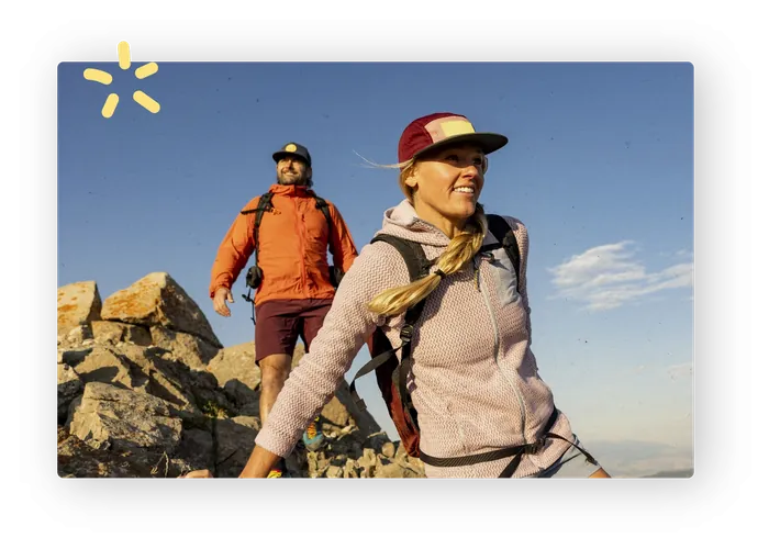 Two hikers on a rocky ridge in late afternoon sun